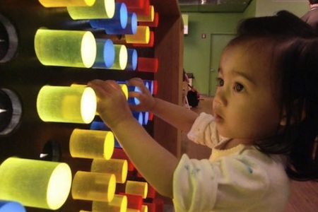 young girl at Light Board Exhibit