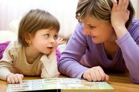 young girl and Mom reading together